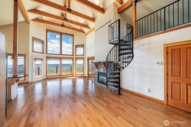 27 Scenic Dr, Brewster, WA 98812 - living area featuring high vaulted ceiling, beamed ceiling, baseboards, stairs, and wood finished floors