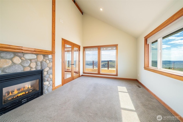 27 Scenic Dr, Brewster, WA 98812 - unfurnished living room featuring french doors, carpet flooring, baseboards, healthy amount of natural light, and high vaulted ceiling