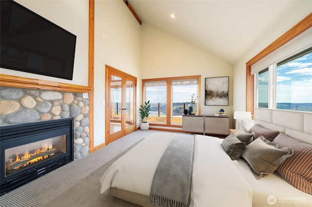 27 Scenic Dr, Brewster, WA 98812 - bedroom with access to outside, a stone fireplace, multiple windows, french doors, and high vaulted ceiling
