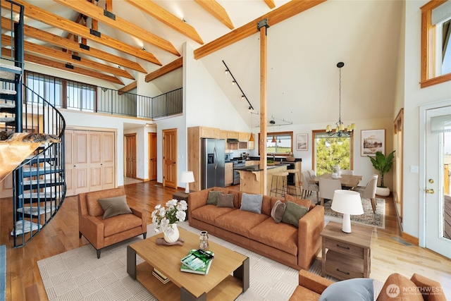 27 Scenic Dr, Brewster, WA 98812 - living area with high vaulted ceiling, light wood-style flooring, plenty of natural light, a chandelier, and stairway