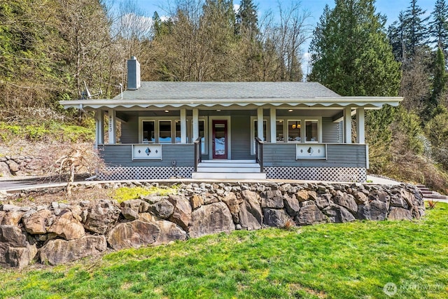 4723 Parker Rd E, Sumner, WA 98390 - view of front of house featuring a porch, a chimney, and a front yard