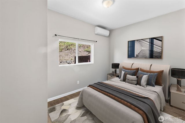 4723 Parker Rd E, Sumner, WA 98390 - bedroom featuring baseboards, wood finished floors, and an AC wall unit