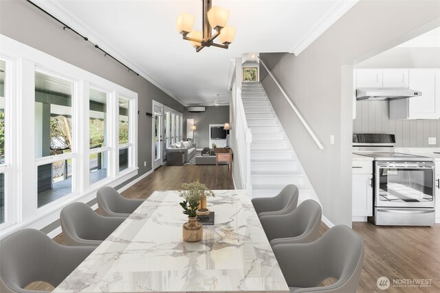 4723 Parker Rd E, Sumner, WA 98390 - dining room with crown molding, dark wood-type flooring, stairway, and a notable chandelier