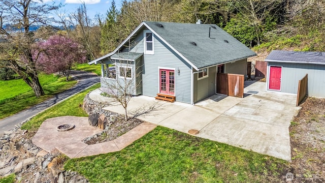4723 Parker Rd E, Sumner, WA 98390 - view of front of house featuring a fire pit, concrete driveway, and a patio