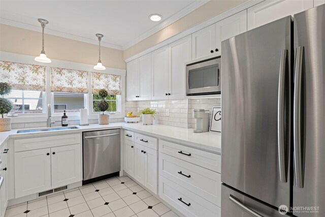 3119 108th Ave SE, Bellevue, WA 98004 - kitchen with appliances with stainless steel finishes, a sink, crown molding, light countertops, and white cabinets