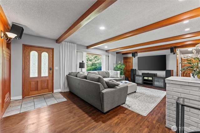 9811 NE 152nd Ave, Vancouver, WA 98682 - living area with beam ceiling, a textured ceiling, baseboards, wood finished floors, and a fireplace
