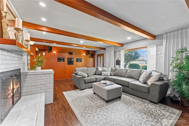 9811 NE 152nd Ave, Vancouver, WA 98682 - living room featuring recessed lighting, wood finished floors, beam ceiling, a fireplace, and a textured ceiling