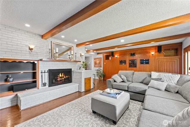 9811 NE 152nd Ave, Vancouver, WA 98682 - living room with recessed lighting, wood finished floors, beam ceiling, a fireplace, and a textured ceiling