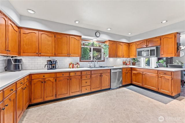 9811 NE 152nd Ave, Vancouver, WA 98682 - kitchen featuring stainless steel appliances, light countertops, a sink, and brown cabinets