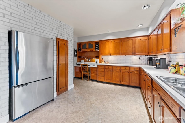 9811 NE 152nd Ave, Vancouver, WA 98682 - kitchen featuring decorative backsplash, light countertops, freestanding refrigerator, and brown cabinets