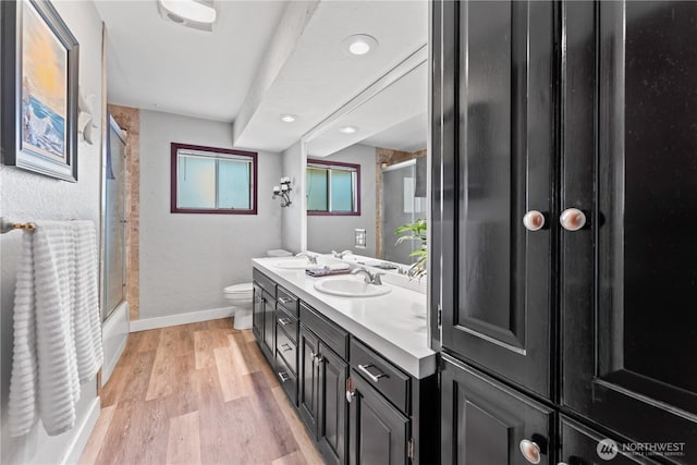 9811 NE 152nd Ave, Vancouver, WA 98682 - bathroom with double vanity, wood finished floors, toilet, and a sink
