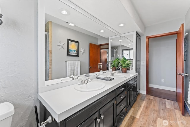 9811 NE 152nd Ave, Vancouver, WA 98682 - full bathroom with wood finished floors, a sink, double vanity, and recessed lighting