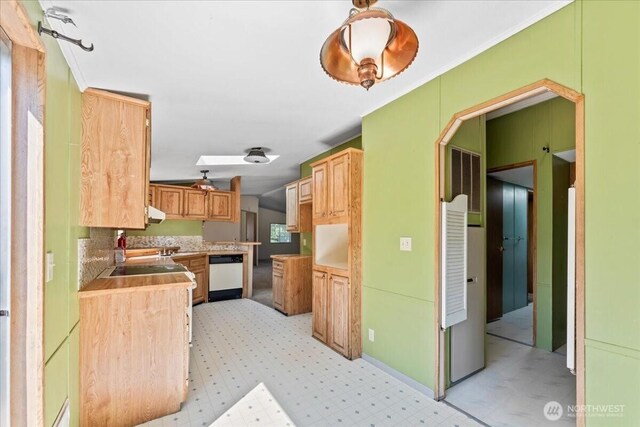 9811 NE 152nd Ave, Vancouver, WA 98682 - kitchen featuring light brown cabinetry, light countertops, vaulted ceiling, white dishwasher, and tasteful backsplash