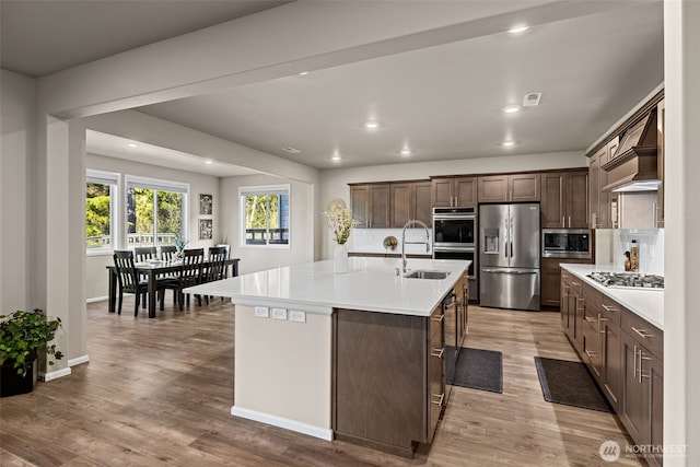 32832 SE Stevens St, Black Diamond, WA 98010 - kitchen with dark brown cabinets, light countertops, tasteful backsplash, a sink, and appliances with stainless steel finishes