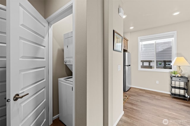 32832 SE Stevens St, Black Diamond, WA 98010 - washroom with stacked washer / drying machine, laundry area, light wood-style flooring, recessed lighting, and baseboards