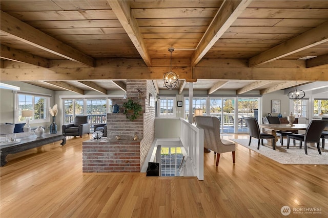 7501 Stinson Ave, Gig Harbor, WA 98335 - dining area featuring wood finished floors, a healthy amount of sunlight, beamed ceiling, wood ceiling, and a chandelier