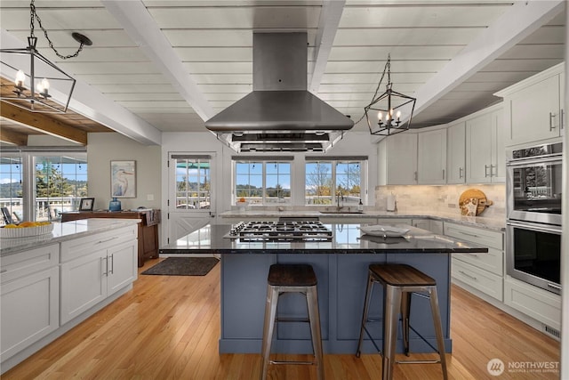 7501 Stinson Ave, Gig Harbor, WA 98335 - kitchen featuring an inviting chandelier, a sink, beamed ceiling, wall chimney exhaust hood, and appliances with stainless steel finishes