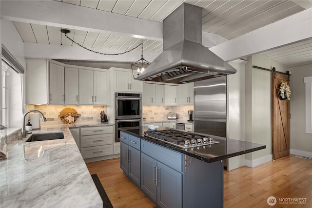 7501 Stinson Ave, Gig Harbor, WA 98335 - kitchen featuring a barn door, island exhaust hood, stainless steel appliances, a sink, and wood ceiling