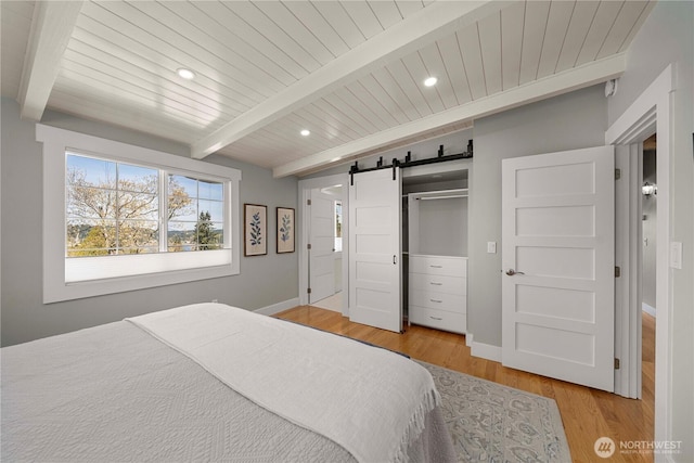 7501 Stinson Ave, Gig Harbor, WA 98335 - bedroom featuring a barn door, recessed lighting, beamed ceiling, wood finished floors, and wooden ceiling