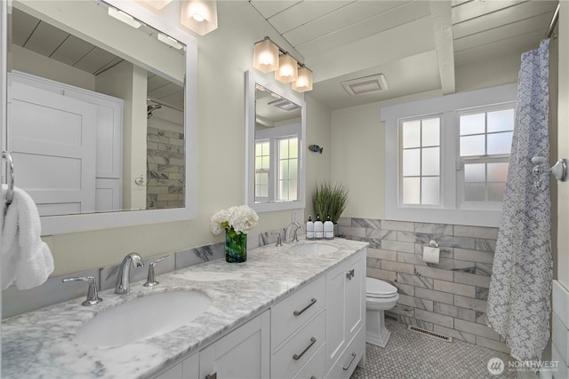 7501 Stinson Ave, Gig Harbor, WA 98335 - full bathroom with visible vents, a sink, and a healthy amount of sunlight