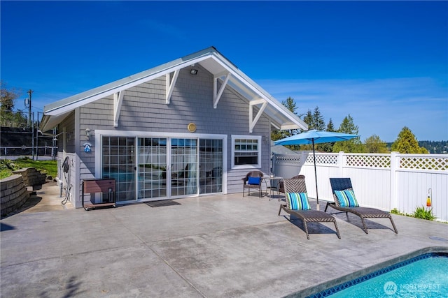 7501 Stinson Ave, Gig Harbor, WA 98335 - back of property featuring fence, a patio area, and a fenced in pool