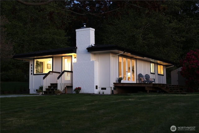 4182 Scatchet View Dr, Clinton, WA 98236 - view of front of home with a chimney and a front lawn
