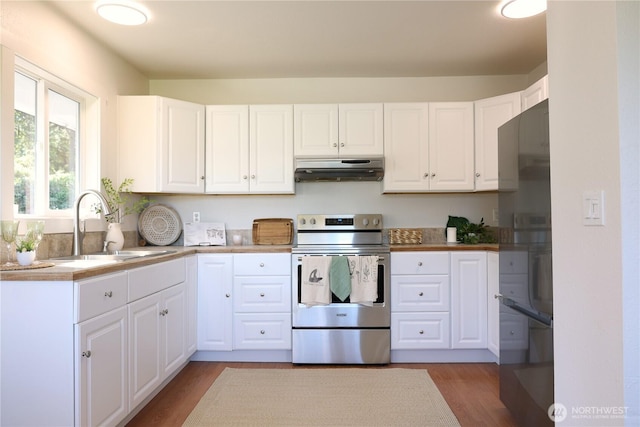 4182 Scatchet View Dr, Clinton, WA 98236 - kitchen featuring under cabinet range hood, a sink, stainless steel range with electric cooktop, wood finished floors, and white cabinets