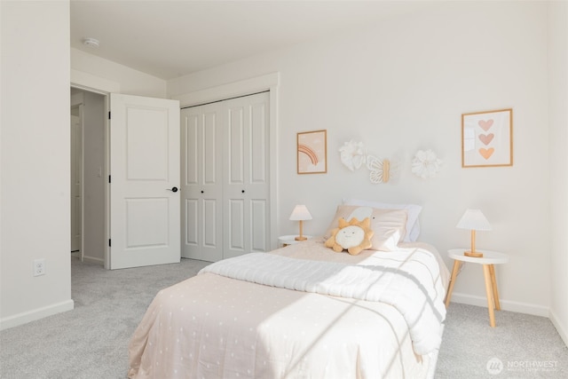bedroom featuring a closet, carpet flooring, and baseboards