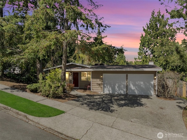 view of front of home with concrete driveway and a garage