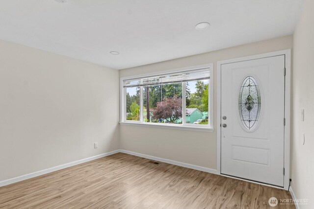 foyer with light wood-style flooring, baseboards, and recessed lighting