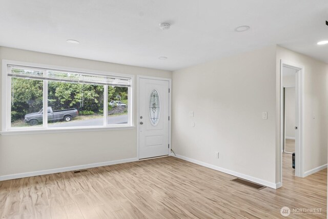 foyer with baseboards, light wood-style flooring, and recessed lighting
