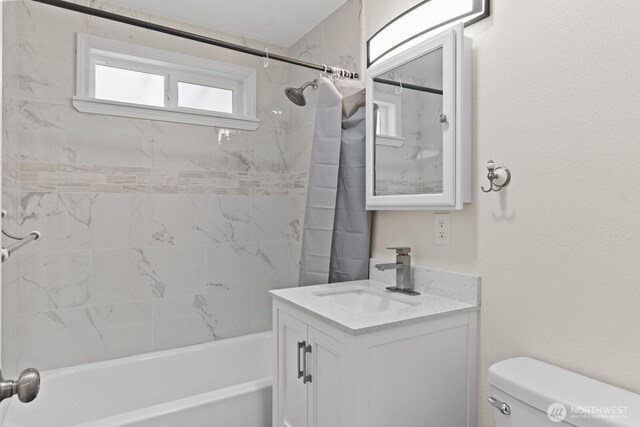 full bathroom with shower / bath combo with shower curtain, toilet, and vanity