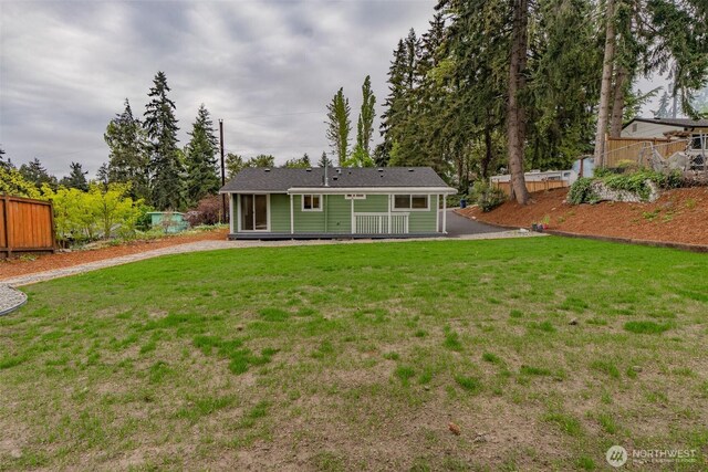 rear view of property featuring driveway