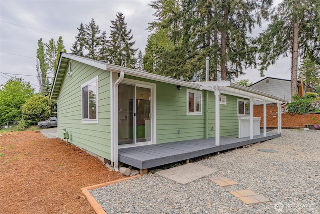rear view of house with a wooden deck
