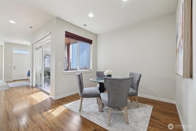 dining room featuring recessed lighting, wood finished floors, visible vents, and baseboards