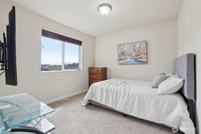 bedroom with carpet floors, visible vents, and baseboards