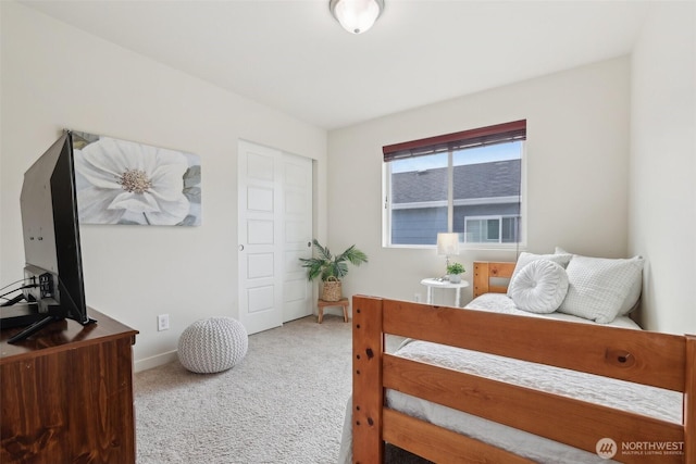 bedroom with carpet floors and baseboards