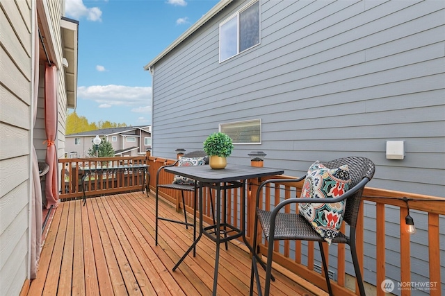 wooden deck featuring outdoor dining space