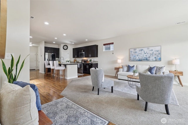 12226 SE 293rd St, Auburn, WA 98092 - living room with recessed lighting, baseboards, and light wood-type flooring