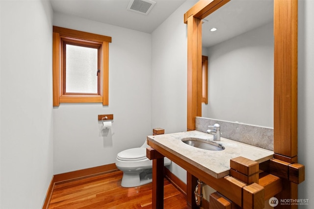 3103 Alki Ave SW, Seattle, WA 98116 - bathroom featuring wood finished floors, toilet, baseboards, and vanity
