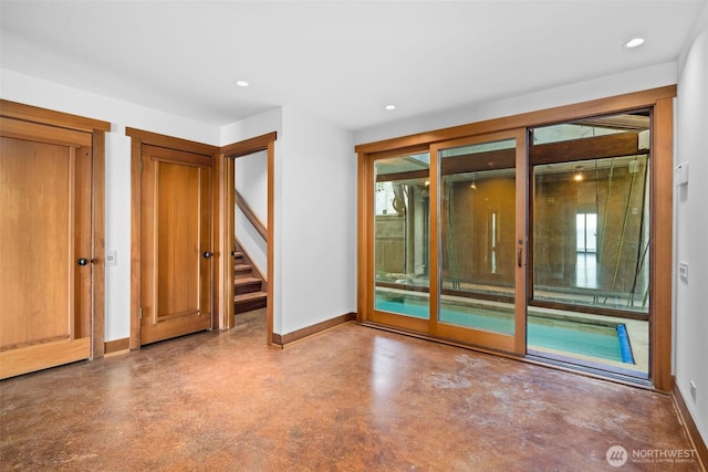 3103 Alki Ave SW, Seattle, WA 98116 - unfurnished room with finished concrete flooring, baseboards, recessed lighting, and stairs