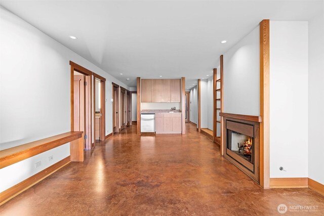3103 Alki Ave SW, Seattle, WA 98116 - unfurnished living room with baseboards, concrete flooring, recessed lighting, and a warm lit fireplace