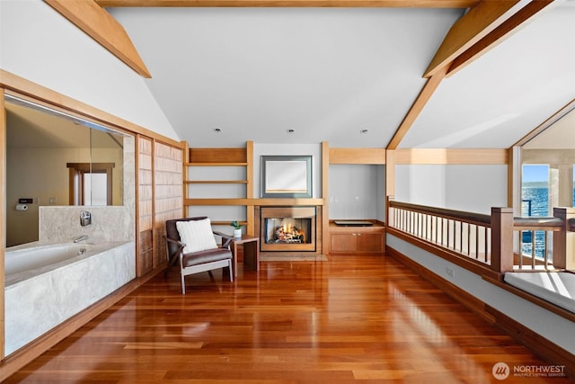 3103 Alki Ave SW, Seattle, WA 98116 - sitting room featuring vaulted ceiling, a multi sided fireplace, and wood finished floors