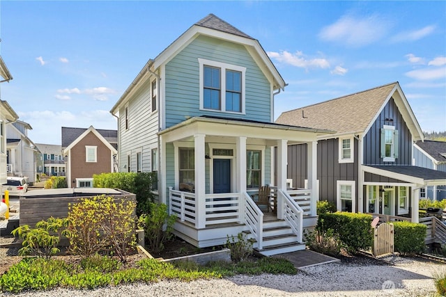 view of front of property featuring board and batten siding, a shingled roof, and covered porch