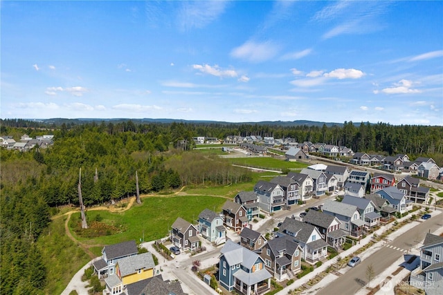 drone / aerial view with a forest view and a residential view