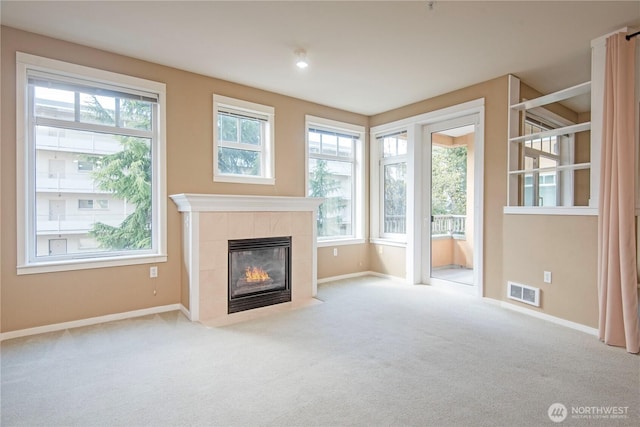 unfurnished living room with baseboards, carpet flooring, and visible vents