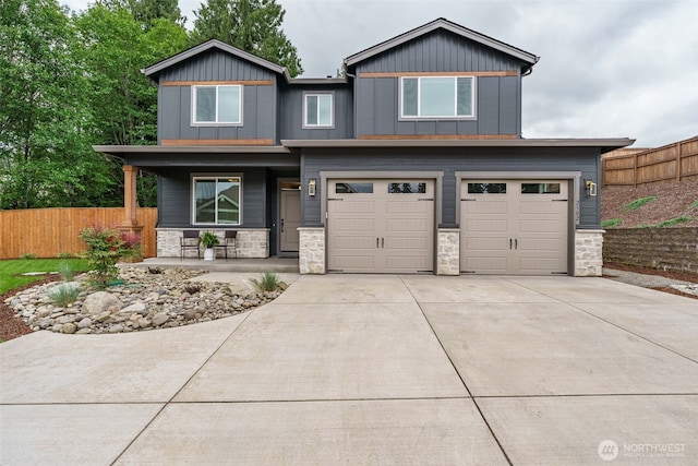 2302 S Royal Ct, Ridgefield, WA 98642 - view of front of property featuring a porch, stone siding, an attached garage, concrete driveway, and board and batten siding