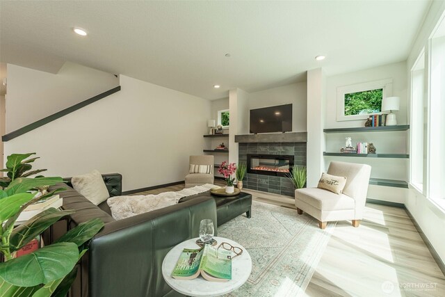 2302 S Royal Ct, Ridgefield, WA 98642 - living room with light wood-style flooring, plenty of natural light, a tiled fireplace, recessed lighting, and baseboards