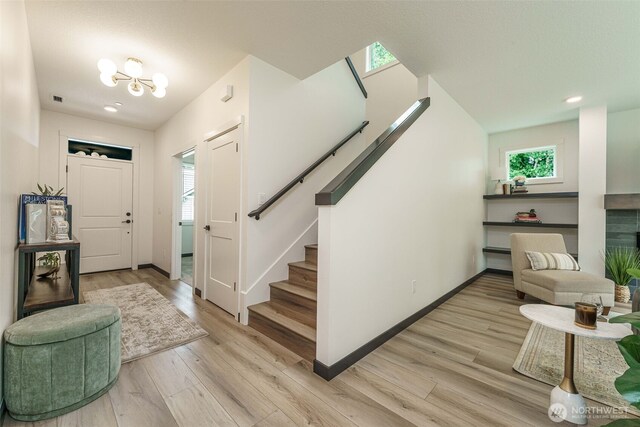 2302 S Royal Ct, Ridgefield, WA 98642 - foyer featuring stairway, light wood-style flooring, baseboards, a fireplace, and recessed lighting