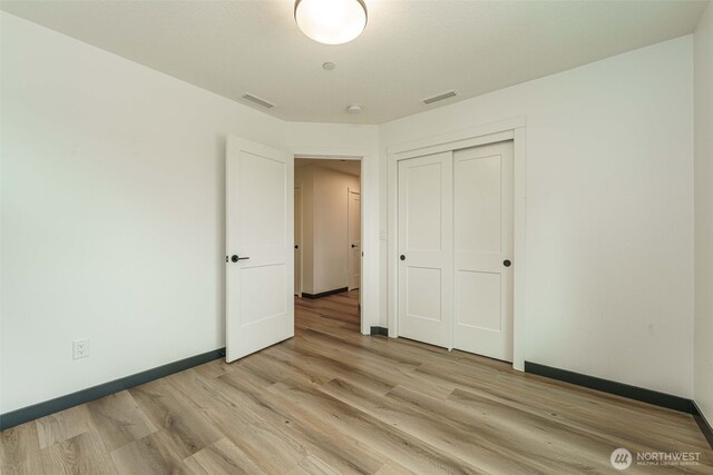 2302 S Royal Ct, Ridgefield, WA 98642 - unfurnished bedroom with light wood-style floors, baseboards, and a closet